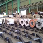 Industrial Steel, Aluminum, And Copper Coils Stored Safely On Skids In A Modern Mill