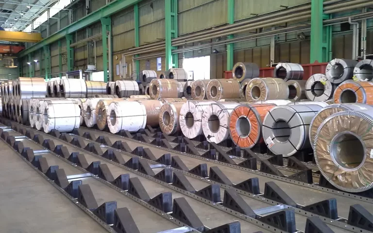 Industrial Steel, Aluminum, And Copper Coils Stored Safely On Skids In A Modern Mill