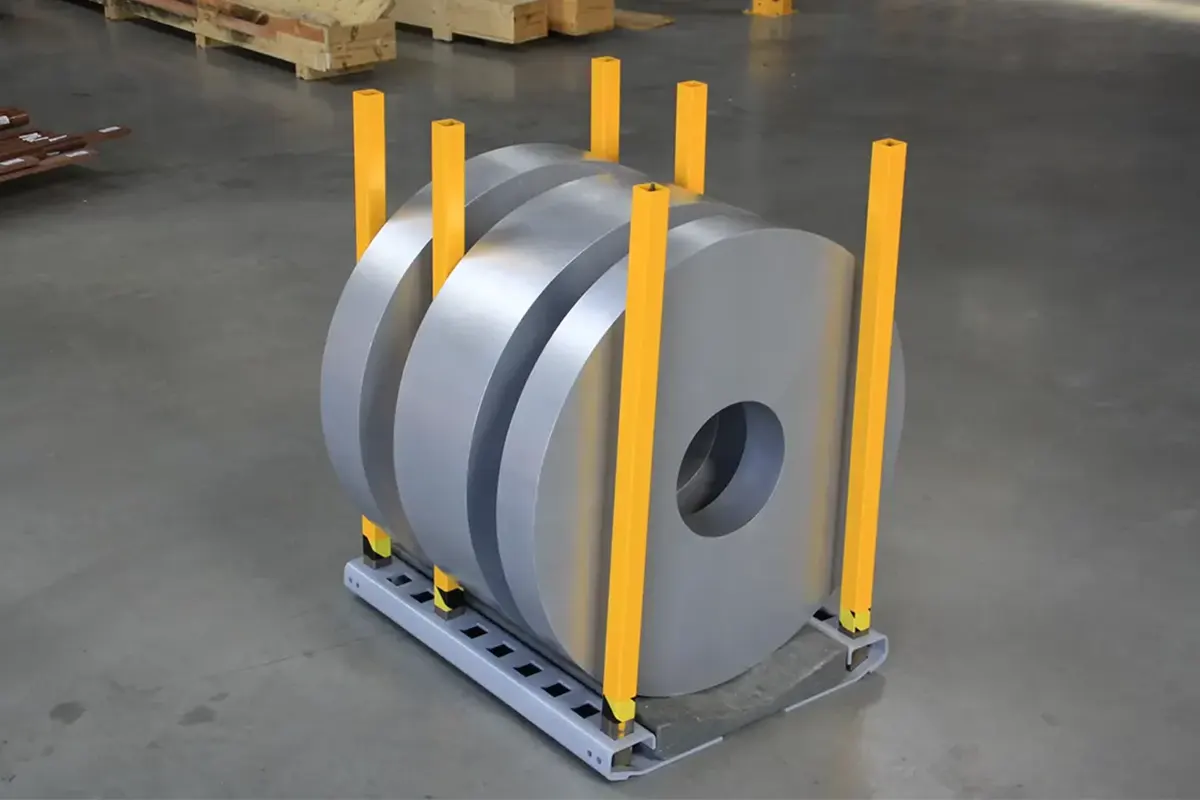 Slitted narrow steel coils stored safely on heavy-duty European-engineered coil cradles and racking systems inside a modern industrial warehouse