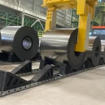 Heavy steel coils supported by engineered coil saddle in a safe coil storage system