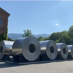Industrial metal coil storage blocks providing surface protection in a steel warehouse.
