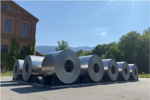 Industrial metal coil storage blocks providing surface protection in a steel warehouse.