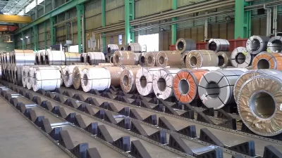 Industrial Steel, Aluminum, And Copper Coils Stored Safely On Skids In A Modern Mill